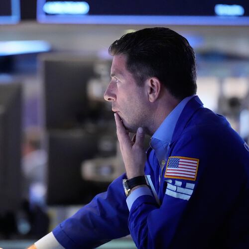 People work on the floor at the New York Stock Exchange in New York, Monday, April 13, 2026. (AP Photo/Seth Wenig)