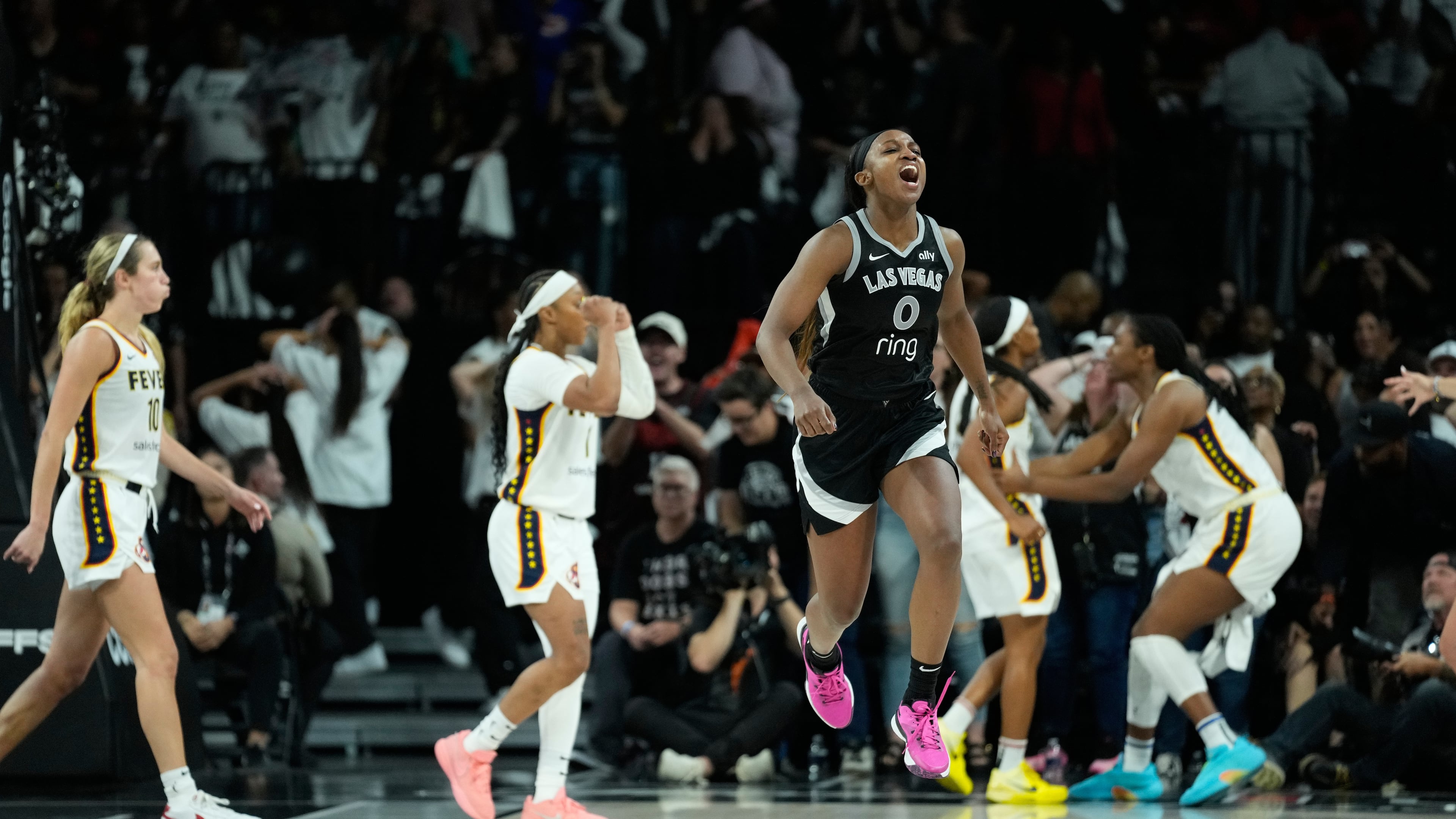 Las Vegas Aces guard Jackie Young (0) reacts after a play against the Indiana Fever during the second period in Game 5 of a WNBA basketball playoff semifinals series Tuesday, Sept. 30, 2025, in Las Vegas. (AP Photo/John Locher)