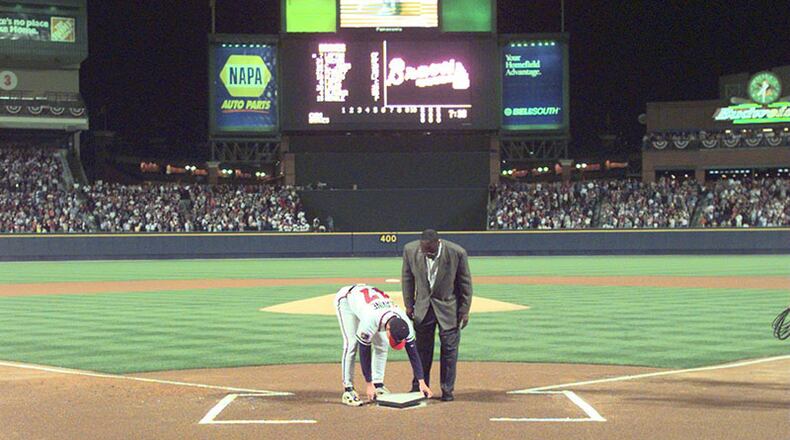 Tom Glavine and Henry Aaron place the ceremonial home plate transferred from Fulton County Stadium during ceremonies before the Braves home opener against the Chicago Cubs in the first regular season game played at the new Turner Field on Friday, April 4, 1997.