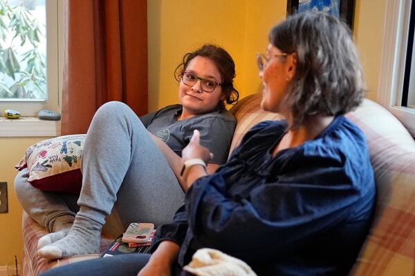 Iris Turmelle talks with her mom, Amy Manzelli, at their home, Wednesday, March 5, 2025, in Pembroke, N.H. (AP Photo/Robert F. Bukaty)