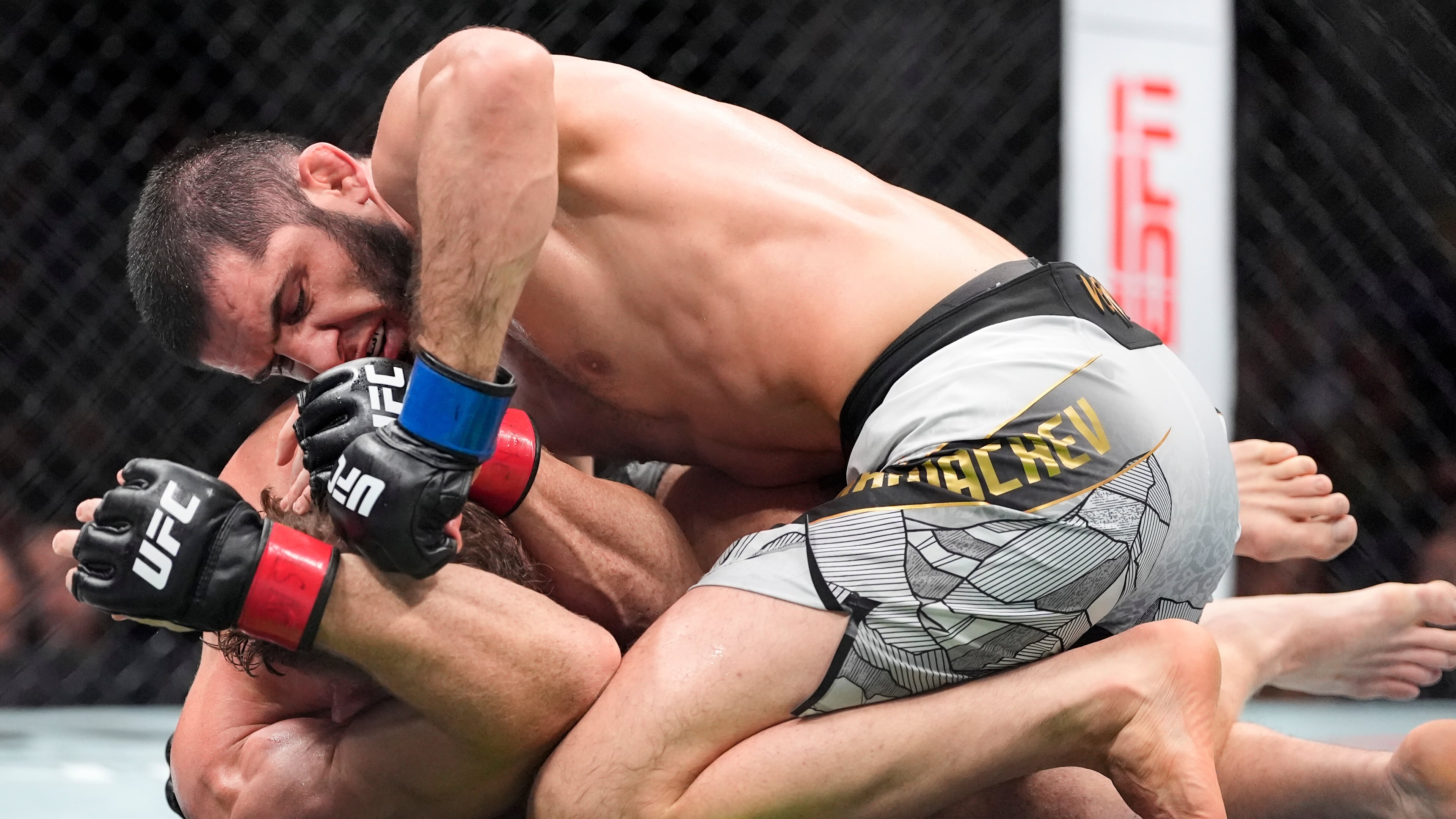 Russia's Islam Makhachev, top, grapples with Australia's Jack Della Maddalena, bottom, during the third round of a welterweight title bout at the UFC 322 mixed martial arts event, Saturday, Nov. 15, 2025, in New York. (AP Photo/Yuki Iwamura)