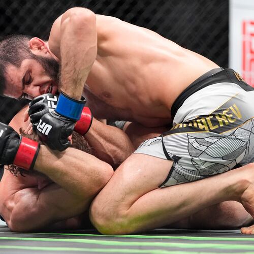 Russia's Islam Makhachev, top, grapples with Australia's Jack Della Maddalena, bottom, during the third round of a welterweight title bout at the UFC 322 mixed martial arts event, Saturday, Nov. 15, 2025, in New York. (AP Photo/Yuki Iwamura)