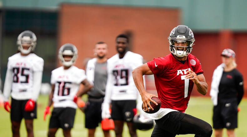 Atlanta Falcons quarterback Marcus Mariota (1) takes part in drills at the NFL football team's practice facility on Saturday, July 30, 2022, in Flowery Branch, Ga. (AP Photo/Brynn Anderson)