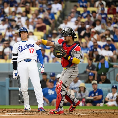 Los Angeles Dodgers' Shohei Ohtani (17) reacts as Arizona Diamondbacks catcher Gabriel Moreno throws during the third inning of a baseball game in Los Angeles, Sunday, July 12, 2026. (AP Photo/Kyusung Gong)