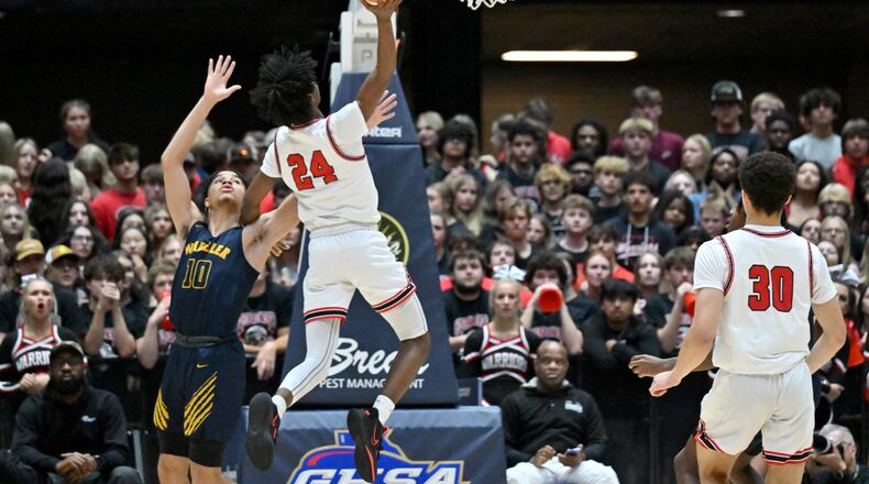 Cherokee's Lawrence Sanford (24) goes up for the shot past Wheeler's Jelani Hamilton (10) during 2023 GHSA Basketball Class 7A Boy’s State Championship game at the Macon Centreplex, Saturday, March 11, 2023, in Macon, GA. (Hyosub Shin / Hyosub.Shin@ajc.com)
