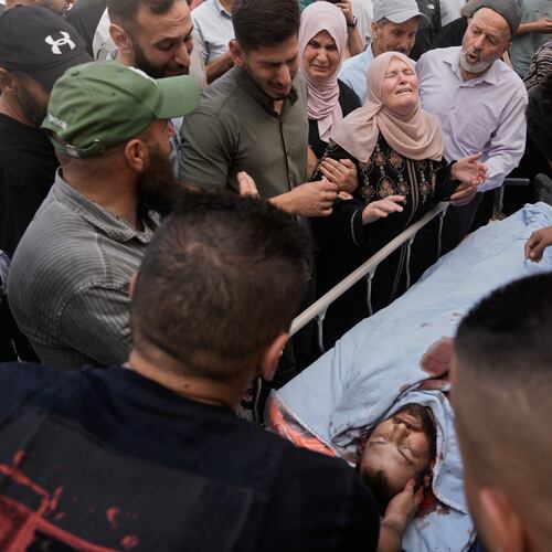 People mourn over the body of Jawad Ramadan, who, according to the Palestinian Health Ministry, was killed by Israeli forces near the village of Tell, after his body was brought to Nablus Speciality Hospital in the West Bank city of Nablus, Friday, July 24, 2026. (AP Photo/Majdi Mohammed)