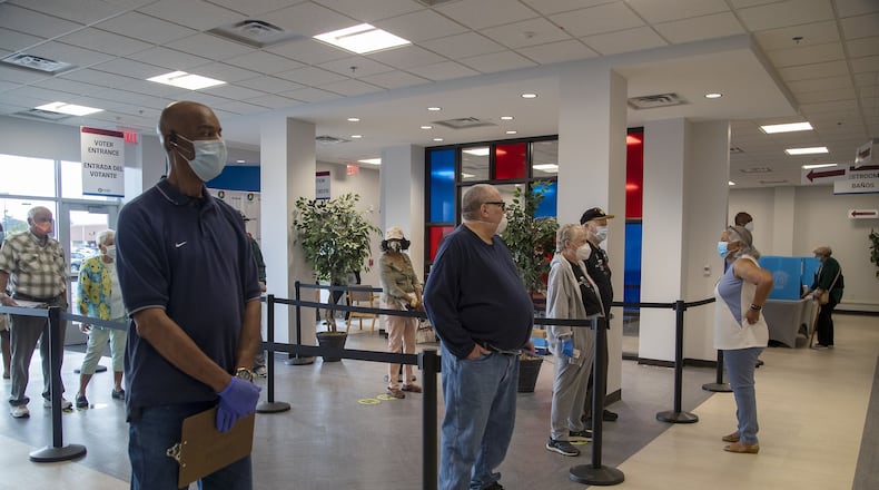 Voters wait in May to gain access to their electronic ballot cards during early voting at the Gwinnett County Voter Registration and Elections Office in Lawrenceville. Election day is Tuesday for Georgia’s combined presidential and general election primary, which had been delayed by the coronavirus pandemic. (ALYSSA POINTER / ALYSSA.POINTER@AJC.COM)