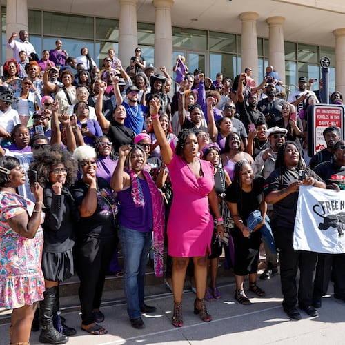 Supporters of Karmelo Anthony chant as they pose for photos outside the Collin County Courthouse after Judge John Roach Jr. was recused from the next phase of Anthony's murder trial, Wednesday, Aug. 19, 2026, in McKinney, Texas. (Elías Valverde II/The Dallas Morning News via AP)