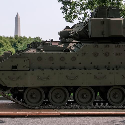FILE - A U.S. Army soldier walks past a Bradley fighting vehicle staged in West Potomac Park ahead of an upcoming military parade commemorating the Army's 250th anniversary and coinciding with Donald Trump's 79th birthday, June 11, 2025, in Washington. (AP Photo/Julia Demaree Nikhinson, File)