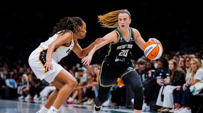 New York Liberty guard Sabrina Ionescu (20) dribbles toward the basket during the first half of a WNBA basketball game against the Indiana Fever, Saturday, Aug. 22, 2026, in New York. (AP Photo/Angelina Katsanis)