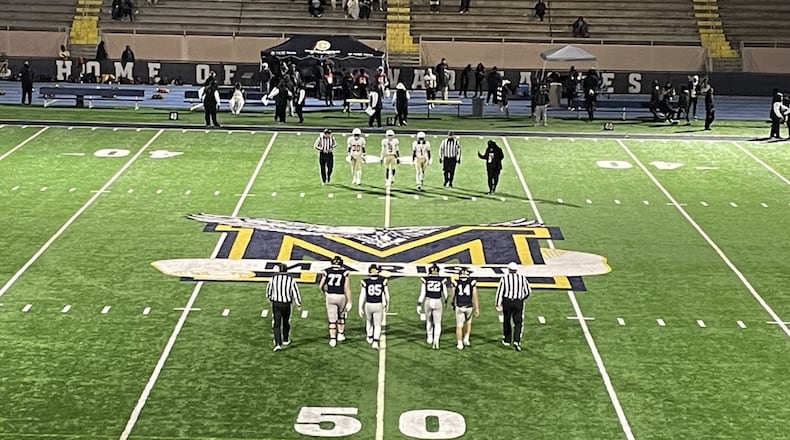 Marist and Creekside captains approach midfield for the coin toss before their Class 4A football semifinal on Dec. 6, 2024, at Marist's Hughes Spalding Stadium. Marist won 27-21 to advance to the state championship game.
