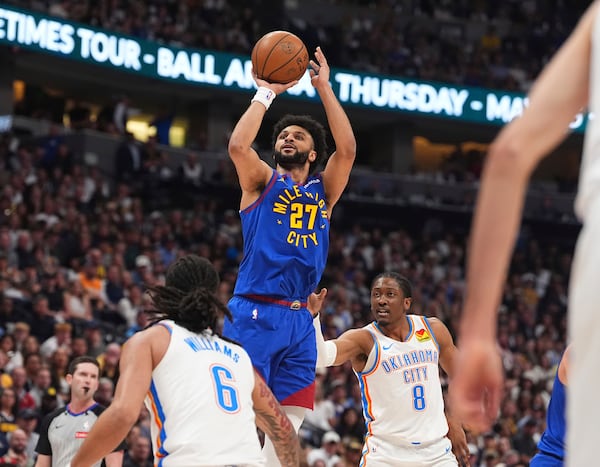 Denver Nuggets guard Jamal Murray (27) goes up for a basket between Oklahoma City Thunder forwards Jaylin Williams (6) and Jalen Williams (8) in the first half of Game 3 in the Western Conference semifinals of the NBA basketball playoffs Friday, May 9, 2025, in Denver. (AP Photo/David Zalubowski)