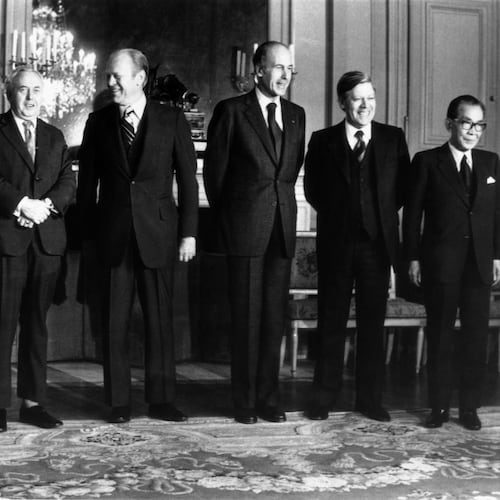 FILE - From left: Premier Aldo Moro of Italy, Premier Harold Wilson of the Great Britain, President Gerald Ford of the United States, President Valery Giscard d'Estaing of France, Chacellor Helmut Schmidt of West Germany and Premier Takeo Miki of Japan, the six heads of state and government, pose for a group portrait during the Economic and Monetary summit meeting at the Chateau de Rambouillet, West of Paris, Nov. 17, 1975. (AP Photo, File)