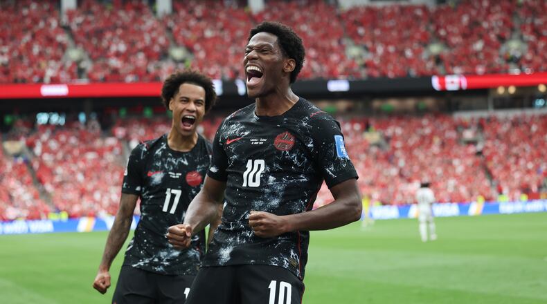 Canada's Jonathan David (10) celebrates after scoring their second goal during the World Cup Group B soccer match between Canada and Qatar in Vancouver, British Columbia, Thursday, June 18, 2026. (AP Photo/Emma Peterson)