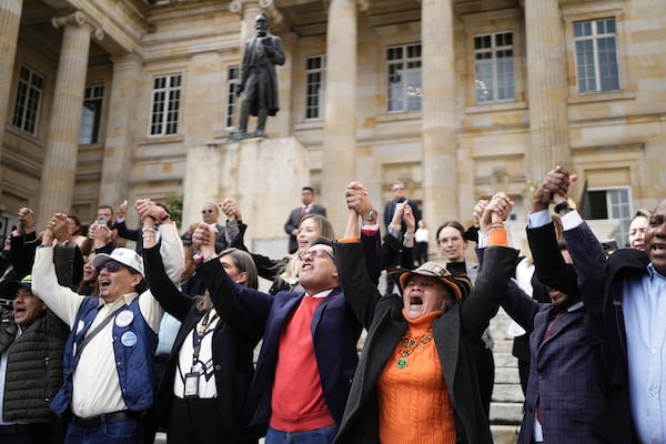 Lawmakers gather outside Congress to show support for Senator Miguel Uribe Turbay while he is in critical condition after being shot at a political rally in Bogota, Colombia, Monday, June 9, 2025. (AP Photo/Ivan Valencia)