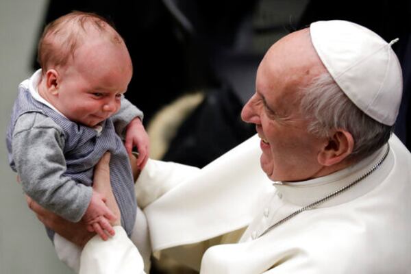 FILE - Pope Francis holds a baby during an audience with members of Entrepreneurs for Economy of Communion, at the Paul VI Hall, at the Vatican, Saturday, Feb. 4, 2017. (AP Photo/Andrew Medichini, File)