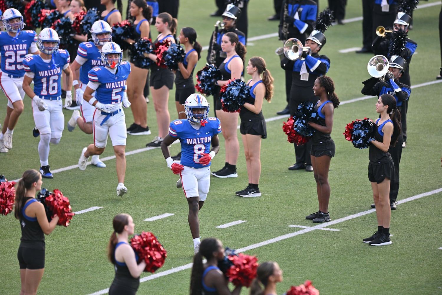 Walton running back Noriega Thompson (8) leads the Raiders onto the field prior to their game against Roswell Friday, August 29, 2025 at Walton High School. (Daniel Varnado/For the Atlanta Journal-Constitution)