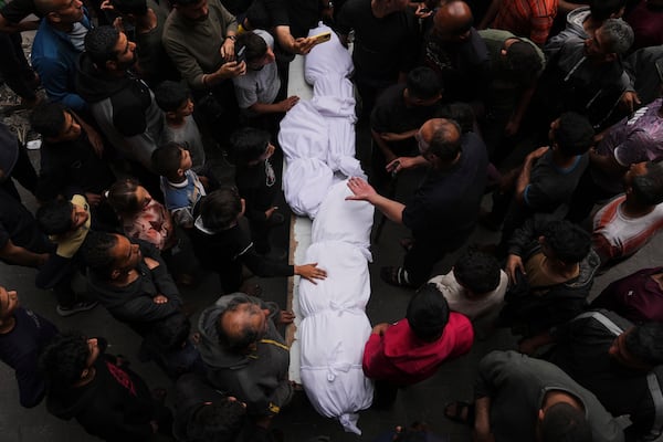 Relatives grieve over the bodies of members of the Jalis and Al-Sharbasi families, killed in an Israeli army airstrike on Yaffa School in Gaza City, Wednesday, April 23, 2025. (AP Photo/Jehad Alshrafi)