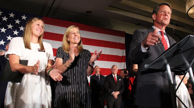 Jarrett and Marty Kemp clap Brian Kemp, right, speaks at a Republican "unity rally." Jenna Eason / Jenna.Eason@coxinc.com