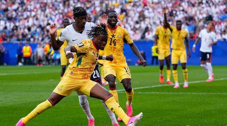 Ghana's Fatawu Issahaku (7) and England's Noni Madueke (20) battle for the ball during the World Cup Group L soccer match between England and Ghana in Foxborough, Mass., near Boston, Tuesday, June 23, 2026. (AP Photo/Petr David Josek)