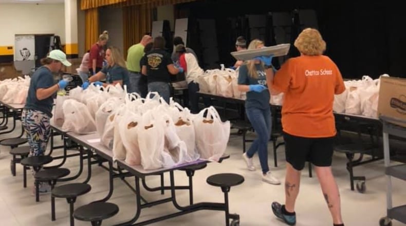 Chattahoochee County School District teachers, cafeteria workers and other staffers packaged free meals for delivery to students last spring after schools closed due to COVID-19. CONTRIBUTED
