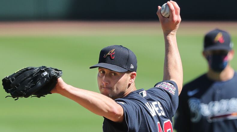 Atlanta Braves pitcher Nate Jones delivers a pitch during live batting pratice with coach Drew French (background) looking on at spring training Thursday, Feb. 25, 2021, at CoolToday Park in North Port, Fla. (Curtis Compton / Curtis.Compton@ajc.com)