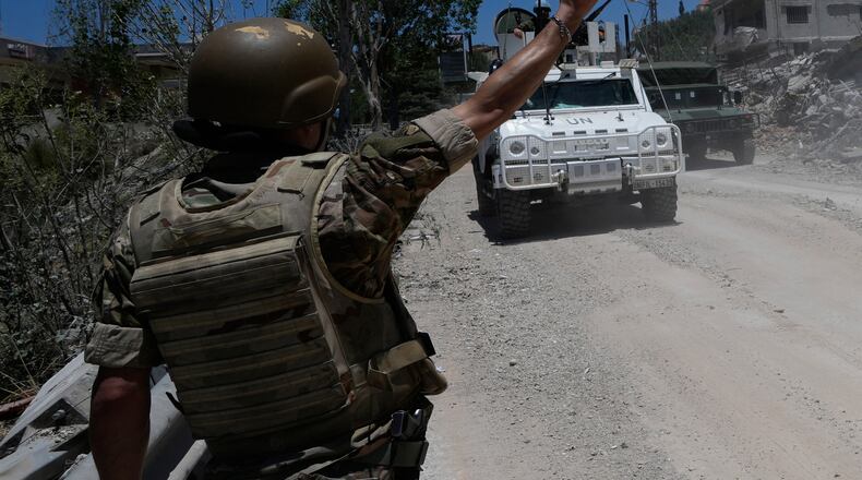A Lebanese soldier gestures in front of a Spanish U.N peacekeeper vehicle Dibbine village, southeast Lebanon, Friday, June 5, 2026, a day after Israeli forces withdrew following clashes with Hezbollah fighters. (AP Photo/Hussein Malla)