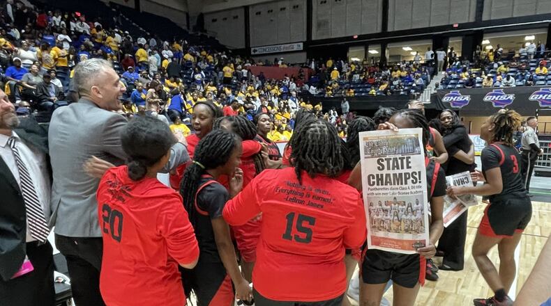 Clinch County players and coaches celebrate their 45-42 victory over Lake Oconee Academy in the Class A Division II girls basketball championship game at the Macon Coliseum on March 8, 2023.