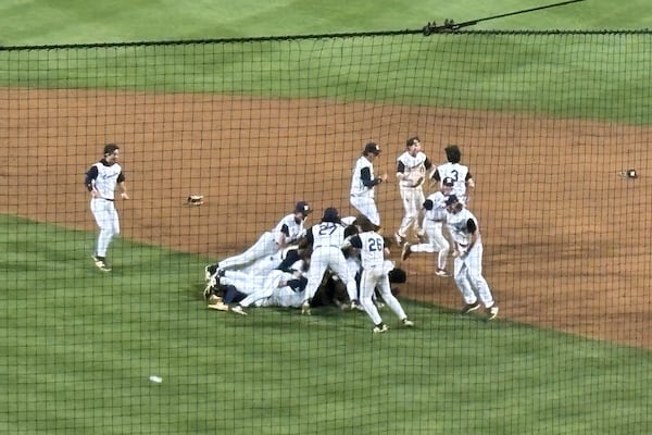 Newnan celebrates its victory over Houston County in the Class 5A championship series May 19, 2025, at Coolray Field.