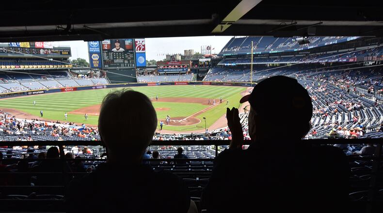 Braves fans Seaton and Lucille Smith (foreground) cheer during Atlanta Braves home game against the San Francisco Giants at Turner Field on Thursday, June 2, 2016.