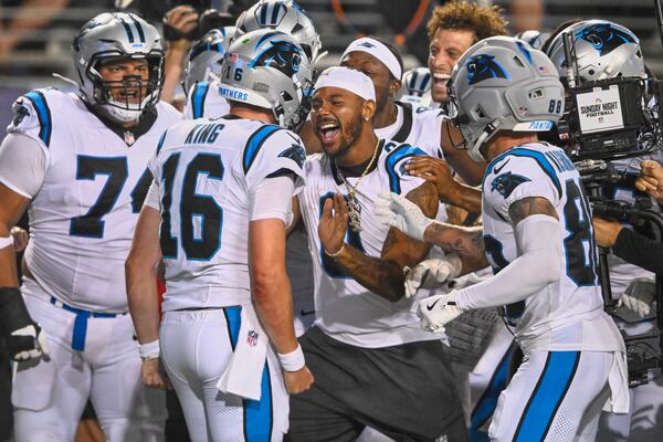 Panthers teammates rush to celebrate with quarterback Haynes King after King scored a touchdown on the last play of their Pro Football Hall of Fame game against the Cardinals on Thursday, Aug. 6, 2026, in Canton, Ohio. (David Richard/AP)