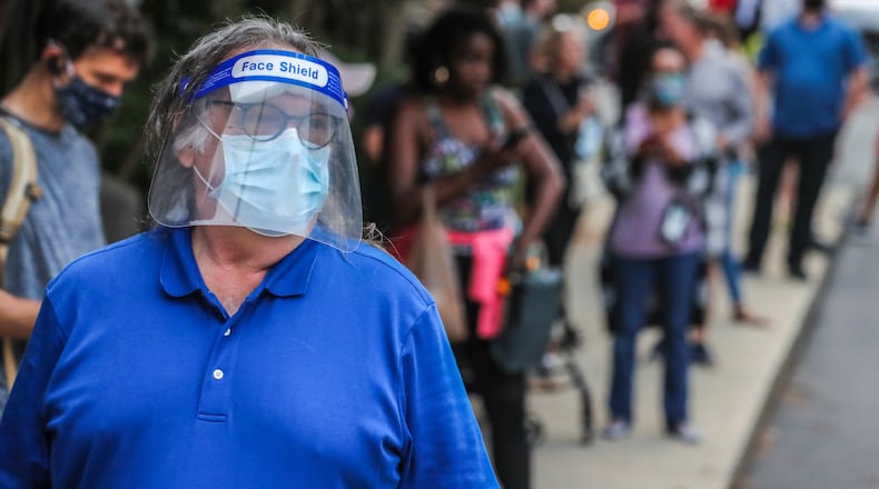 Tom Mroz wears a face shield and mask while waiting to vote June 9 in the Georgia primary at the Park Tavern polling place in Atlanta. Election officials are hoping to avoid the many problems that occurred that day, forcing voters at some precincts to wait hours to cast their ballots. JOHN SPINK/JSPINK@AJC.COM