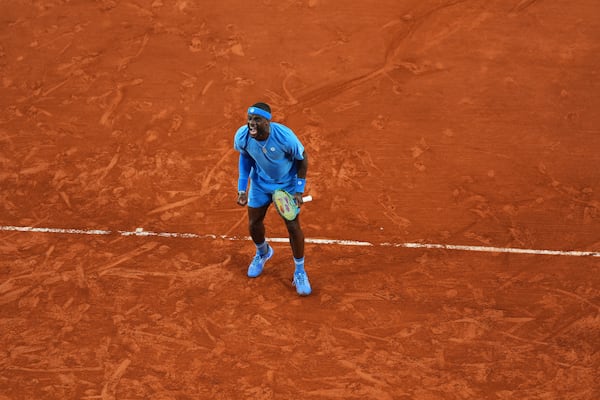 Frances Tiafoe of the U.S. celebrates beating Germany's Daniel Altmaier during their fourth round match of the French Tennis Open, at the Roland-Garros stadium, in Paris, Sunday, June 1 2025. (AP Photo/Lindsey Wasson)