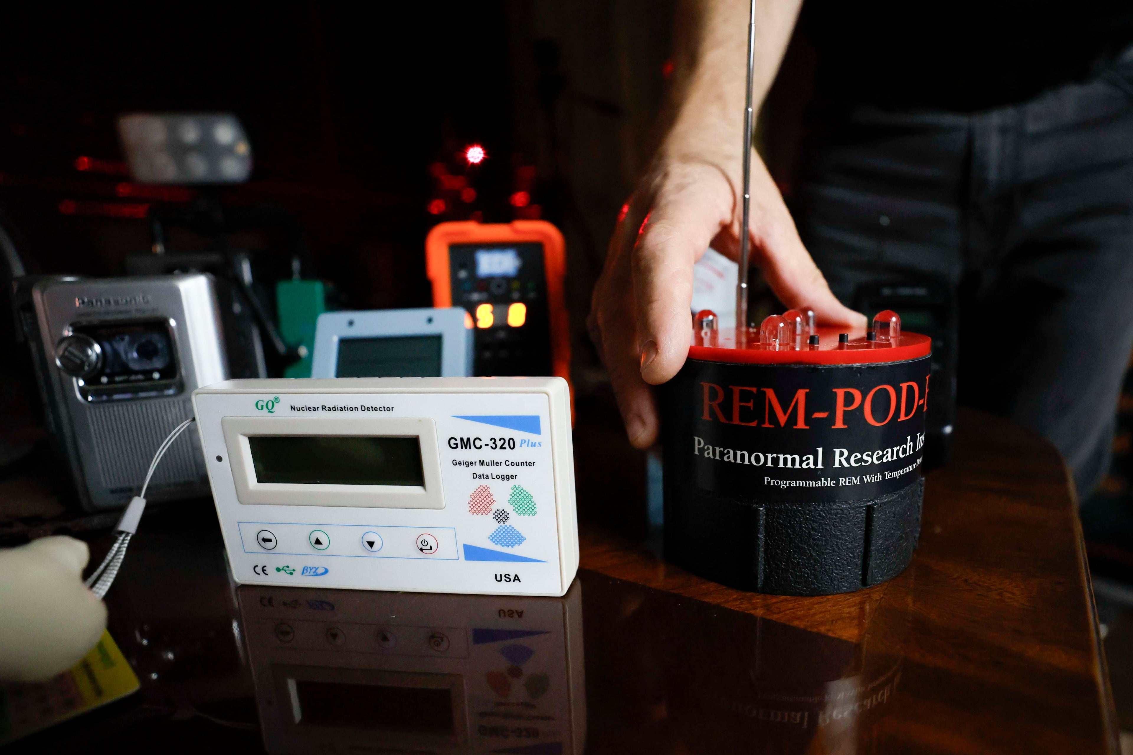 Paranormal investigator Philip Wyatt holds a Paranormal Detector Instrument, and on the right side, it's a Nuclear Radiation Detector Instrument; Wednesday, Oct. 13, 2025. Wyatt has been investigating paranormal events for 15 years, a pursuit that began after personal experiences sparked his interest. (Miguel Martinez/AJC)