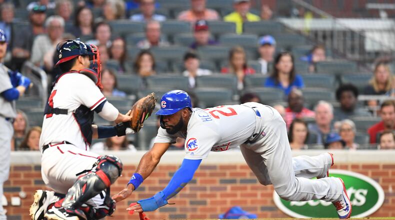 The Cubs’ Jason Heyward scores a run in the second inning Thursday night at SunTrust Park.