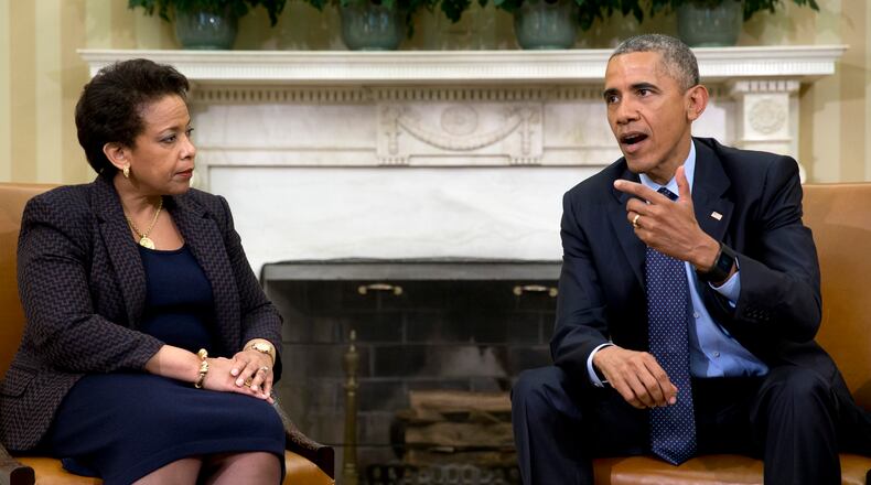 In this May 29, 2015 file photo, President Barack Obama talks with Attorney General Loretta Lynch in the Oval Office of the White House in Washington. Obama will meet with Lynch to discuss a three-month review of what actions he could take to help reduce gun violence. (AP Photo/Carolyn Kaster, File)