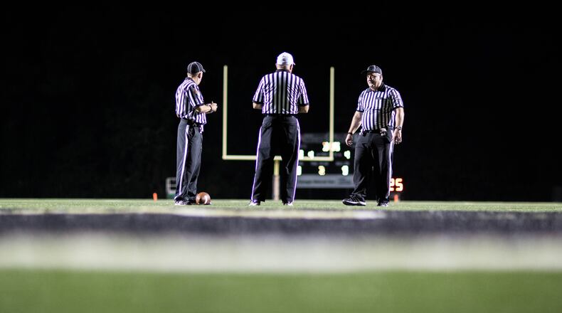 Officials wait on the field during a time out by Cambridge High School during a game against Sprayberry High School in Marietta in this file photo. Cambridge takes on Milton High School on Friday.