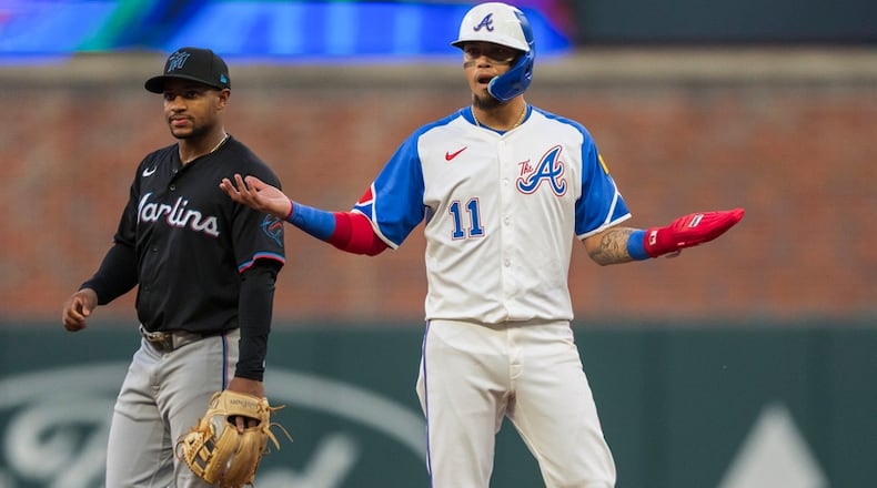 Atlanta Braves Orlando Arcia (11) reacts after a base hit by Atlanta Braves Matt Olson in the third inning of a baseball game against the Miami Marlins, Saturday, Aug. 3, 2024, in Atlanta. (AP Photo/Jason Allen)