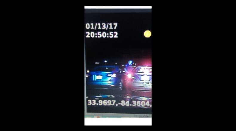 Sandy Springs police are seeking to identify the blue car in the photo after an officer was struck during a traffic stop. (Credit: Sandy Springs police)