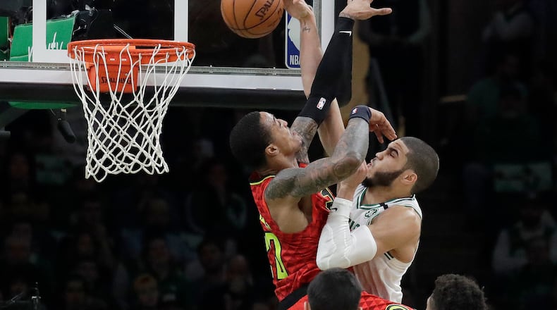 Hawks forward John Collins, left, contests a shot by Boston's Jayson Tatum. (AP Photo/Elise Amendola)