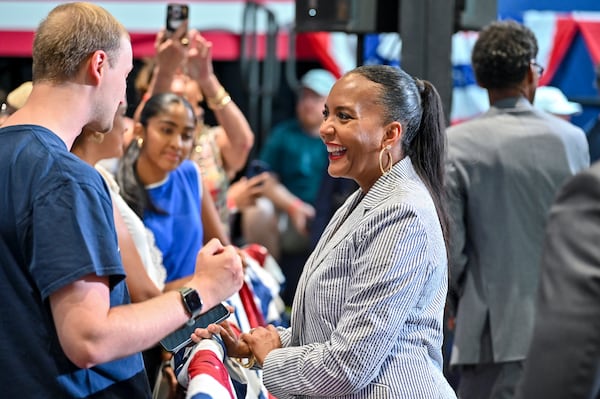 Democratic nominee for governor Keisha Lance Bottoms engages in conversation with an attendee at a rally last month in Savannah. (Sarah Peacock for the AJC)