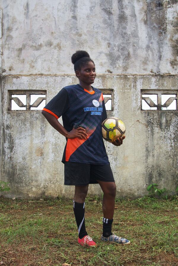 Perryline Jimmie, 23, on the Gisa kickball team, poses for a photo after a match at the Samuel Kanyon Doe Stadium in Monrovia, Liberia, June 14, 2025. (AP Photo/Annie Risemberg)