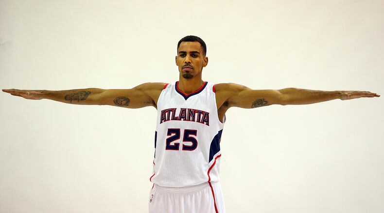 092914 ATLANTA: Hawks guard Thabo Sefolosha shows off his wing span while posing for a portrait during Media Day at Philips Arena on Monday, Sept. 29, 2014, in Atlanta.