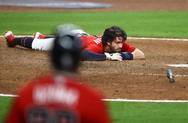 Dansby Swanson was called out after diving home around Phillies catcher Andrew Knapp in what would have been the tying run in the ninth inning Sunday, Aug. 23, 2020, at Truist Park in Atlanta.