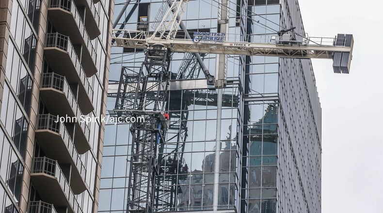 Crews worked all day Friday to stabilize a leaning crane at a 31-story office building in Midtown.