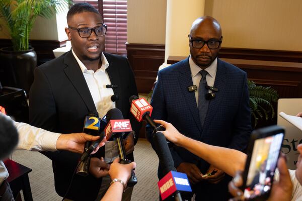 Stockbridge Mayor Jayden Williams (left) and his lawyer, Robert Kenner Jr., speak to journalists Saturday, Aug. 22, 2026, following a City Council hearing held before an upcoming investigative hearing. (Ben Gray for the AJC)