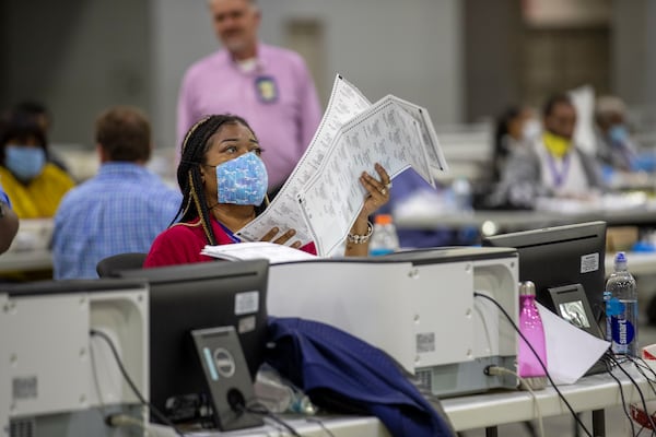 Fulton County employee Shaye Moss scans mail-in paper ballots at the Georgia World Congress Center during the Georgia primary elections, Tuesday, June 9, 2020. (Alyssa Pointer/AJC)