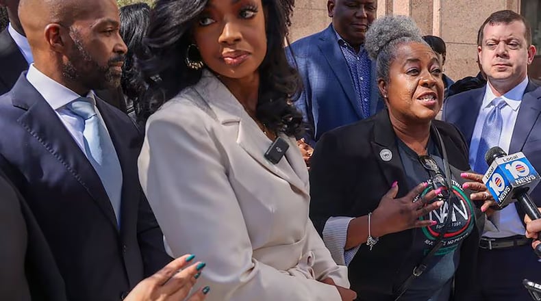 Alphonso David (left), Arian Simone, Fearless Fund co-founder/ CEO, and others listen as Serena Paramore, of the National Action Network, gives her remarks after appearing in federal court at the James Lawrence King Federal Justice Building on Jan. 31, 2024, in Miami. (Carl Juste/Miami Herald/TNS)
