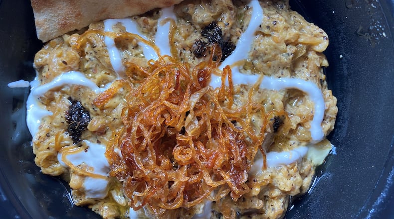 Kashk Bademjoon oven-roasted eggplant with crispy mint, fried onion, cream of whey, and housemade pita bread at Zafron Restaurant in Sandy Springs.
Bob Townsend for the Atlanta Journal-Constitution.