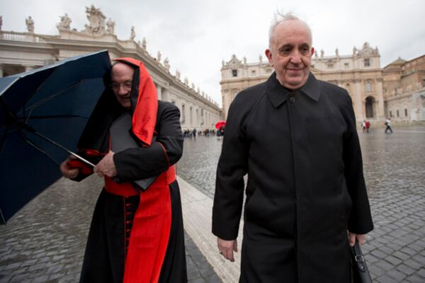 FILE - Canadian Cardinal Marc Ouellet, left, holds on to his umbrella next to Argentine Cardinal Jorge Mario Bergoglio as they walk in St. Peter's Square after attending a cardinals' meeting, at the Vatican, Wednesday, March 6, 2013. (AP Photo/Andrew Medichini, File)